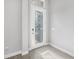 Bright foyer featuring a decorative glass front door and wood-look tile flooring at 6263 W Fallsgrove Ln, Port Orange, FL 32128