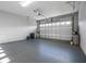 Well-lit, spacious garage featuring a clean epoxy floor and an automatic garage door at 6263 W Fallsgrove Ln, Port Orange, FL 32128