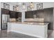 Modern kitchen featuring dark cabinets, stainless steel appliances, and granite countertops at 6263 W Fallsgrove Ln, Port Orange, FL 32128