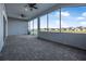 Expansive screened lanai features ceiling fans, lighting, and serene views of the surrounding landscape at 6263 W Fallsgrove Ln, Port Orange, FL 32128