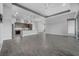 Bright, open living space with wood-look tile flooring and a modern kitchen at 6263 W Fallsgrove Ln, Port Orange, FL 32128