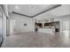 Open-concept living room featuring tile floors, gray walls, and modern ceiling fan at 6263 W Fallsgrove Ln, Port Orange, FL 32128