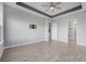Spacious bedroom with tile floor and a ceiling fan and ensuite bathroom at 6263 W Fallsgrove Ln, Port Orange, FL 32128