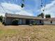 Backyard view featuring a home with a gray exterior and sliding glass doors at 662 Comstock Dr, Deltona, FL 32738
