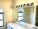Bathroom features a sink with a large mirror and a window inside the shower area at 662 Comstock Dr, Deltona, FL 32738