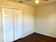Bedroom featuring laminate wood floors and double closet doors at 662 Comstock Dr, Deltona, FL 32738