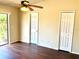 Bedroom with wood floor, ceiling fan, and closet at 662 Comstock Dr, Deltona, FL 32738