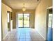 Dining room with tiled floors, a modern chandelier, and a sliding door to the backyard at 662 Comstock Dr, Deltona, FL 32738