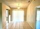 Spacious dining room with tile flooring and a modern chandelier at 662 Comstock Dr, Deltona, FL 32738