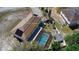 Aerial view of home and backyard with screened-in pool and a detached shed at 707 Leeward Dr, Deltona, FL 32738
