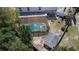 An aerial view of the backyard pool, shed, and surrounding greenery at 707 Leeward Dr, Deltona, FL 32738