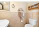 A bathroom has a toilet, vanity with a sink, decorative wall decor, and a mirrored wall cabinet at 707 Leeward Dr, Deltona, FL 32738