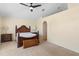 Bedroom with cozy carpet, a ceiling fan, a reading nook, and a decorative headboard at 707 Leeward Dr, Deltona, FL 32738