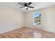 Bedroom featuring a window with natural light and hardwood floors at 707 Leeward Dr, Deltona, FL 32738