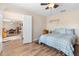 Bedroom with wood-look tile, a ceiling fan, a bed, an open doorway to the dining room at 707 Leeward Dr, Deltona, FL 32738