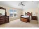Bedroom featuring carpeted floors, a ceiling fan, and large windows for plenty of natural light at 707 Leeward Dr, Deltona, FL 32738