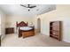 Carpeted bedroom with neutral colors, a ceiling fan, a decorative headboard, and a reading nook at 707 Leeward Dr, Deltona, FL 32738