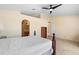 Primary bedroom with an open layout, neutral carpet, an arched doorway and a ceiling fan at 707 Leeward Dr, Deltona, FL 32738