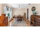 Inviting dining area features wood floors, a wooden table set, and natural light from a large window at 707 Leeward Dr, Deltona, FL 32738