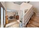 Bright entryway with wood-look floors, a high ceiling, and a staircase with a mobility assistance device at 707 Leeward Dr, Deltona, FL 32738