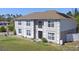 A stately two-story home featuring a classic design, complemented by a well-kept lawn and mature landscaping at 707 Leeward Dr, Deltona, FL 32738