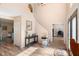 Foyer with wood-look tile, staircase, lift chair, and view of an office space at 707 Leeward Dr, Deltona, FL 32738