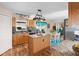 A kitchen island, wood cabinets, granite countertops and an adjacent dining area are visible at 707 Leeward Dr, Deltona, FL 32738