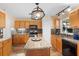 A kitchen features an island, wooden cabinets, granite countertops, backsplash, and stainless steel appliances at 707 Leeward Dr, Deltona, FL 32738