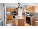 Well-equipped kitchen with stainless steel appliances, a granite-topped island, and dark cabinetry at 707 Leeward Dr, Deltona, FL 32738