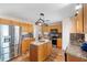 A kitchen featuring an island, wooden cabinets, stainless steel appliances and granite countertops at 707 Leeward Dr, Deltona, FL 32738