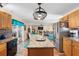 Bright kitchen featuring granite countertops, stainless steel appliances, and a view into the adjacent living room at 707 Leeward Dr, Deltona, FL 32738