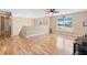 Spacious living room boasts hardwood floors, large windows, and a modern ceiling fan at 707 Leeward Dr, Deltona, FL 32738