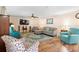 Well-lit living room with comfortable seating, a wall-mounted television, and a ceiling fan at 707 Leeward Dr, Deltona, FL 32738