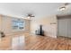 Bright living area features neutral paint, laminate floors, a ceiling fan, and a large window overlooking the yard at 707 Leeward Dr, Deltona, FL 32738