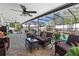 Enclosed patio area with wicker furniture and view of the pool at 707 Leeward Dr, Deltona, FL 32738
