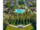 Aerial view of community pool, clubhouse, and surrounding neighborhood, offering resort-style living at 903 Victoria Hills S Dr, Deland, FL 32724