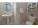 Well-lit half-bathroom featuring a pedestal sink and elegant fixtures at 903 Victoria Hills S Dr, Deland, FL 32724