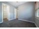 Neutral bedroom with carpet, walk-in closet and large window allowing natural light at 903 Victoria Hills S Dr, Deland, FL 32724