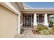 Inviting front entrance with a glass paneled door, flanked by stately columns and well-maintained landscaping at 903 Victoria Hills S Dr, Deland, FL 32724
