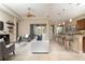 Bright and airy living room with an open layout, ceiling fan, and seamless flow to the kitchen at 903 Victoria Hills S Dr, Deland, FL 32724