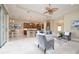 Comfortable living room features a ceiling fan, open floor plan connecting to the kitchen and dining area at 903 Victoria Hills S Dr, Deland, FL 32724
