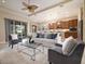 Open-concept living space with sliding glass doors to the backyard, a cozy seating area, and adjacent kitchen at 903 Victoria Hills S Dr, Deland, FL 32724