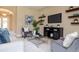 Inviting living room with a plush rug, stylish furniture, and a mounted TV on the wall at 903 Victoria Hills S Dr, Deland, FL 32724