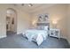 Comfortable main bedroom featuring a tray ceiling, plush carpet, and ample natural light at 903 Victoria Hills S Dr, Deland, FL 32724