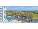 Aerial view of building with tennis courts, parking, and surrounding landscape offering city views at 925 N Halifax Ave # 910, Daytona Beach, FL 32118