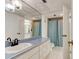 Bathroom featuring a long vanity with a large mirror and shower/tub at 925 N Halifax Ave # 910, Daytona Beach, FL 32118