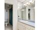 Bathroom featuring a vanity with a large mirror at 925 N Halifax Ave # 910, Daytona Beach, FL 32118