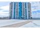 Exterior of condominium building with balconies and view from the roof, showing tennis court and helipad at 925 N Halifax Ave # 910, Daytona Beach, FL 32118