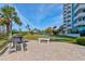 Outdoor common area with picnic tables, benches, and a grill, perfect for gatherings and outdoor dining at 925 N Halifax Ave # 910, Daytona Beach, FL 32118