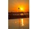 Sunset view of dock on calm waters, capturing a sense of relaxation and waterfront living at 925 N Halifax Ave # 910, Daytona Beach, FL 32118